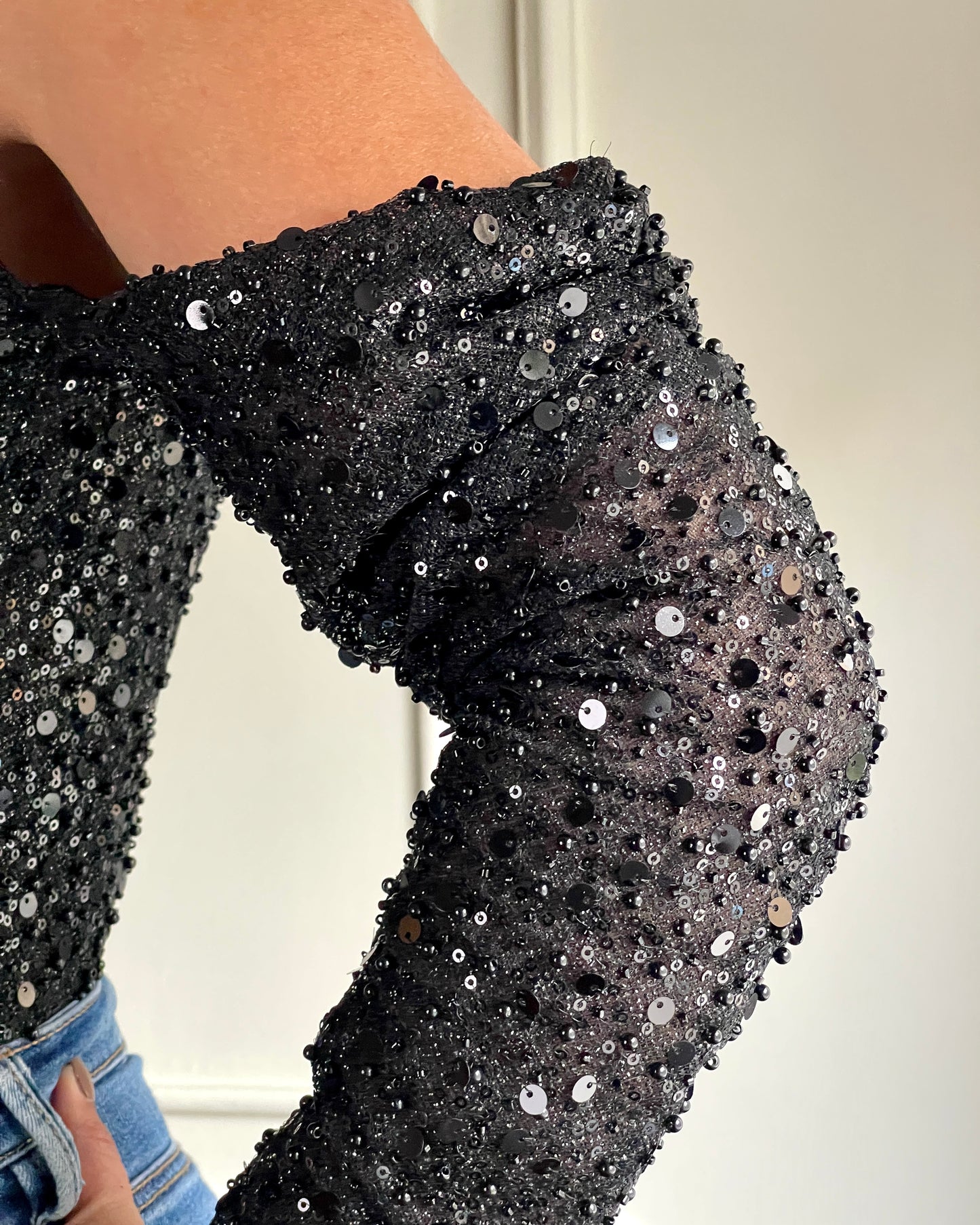 Black off-shoulder bustier with pearls